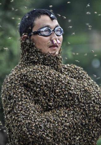 čovjek pokriven pčelama